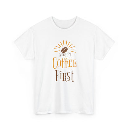 White t-shirt with 'Need My Coffee First' text and coffee bean graphic on a white background