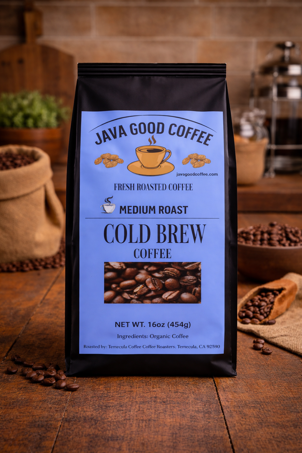 Java Good Coffee cold brew coffee package on a wooden surface with coffee beans and a coffee grinder in the background.
