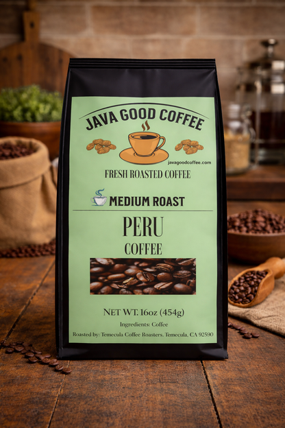 Java Good Coffee Peru coffee package on a wooden surface with coffee beans and a coffee grinder in the background.