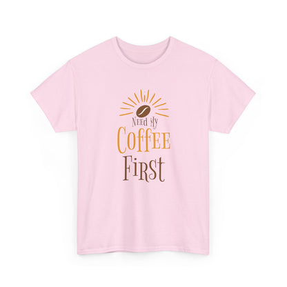 Pink t-shirt with 'Need My Coffee First' text and coffee bean graphic on a white background