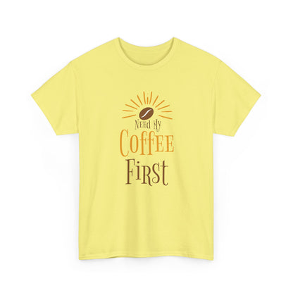 Yellow t-shirt with 'Need My Coffee First' text and coffee bean graphic on a white background