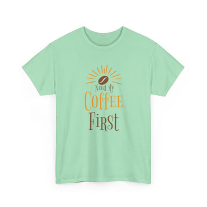 Mint green t-shirt with 'Need My Coffee First' text and sun graphic on a white background