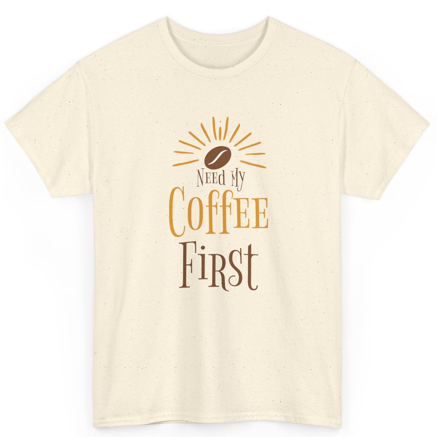 Beige t-shirt with 'Need My Coffee First' text and coffee bean graphic on a white background